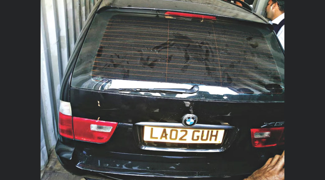 Bidders inspect a Mercedes S-Class, BMW X5 and a Mitsubishi Shogun inside containers at the Chittagong port on May 30. Photo: Collected