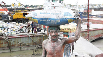 Workers unloading raw materials of cement from a vessel in Chattogram. Bangladesh imports cement raw materials such as clinker, granulated slag, limestone flux, gypsum and fly ash from Thailand, Vietnam and China. Photo: Star/file