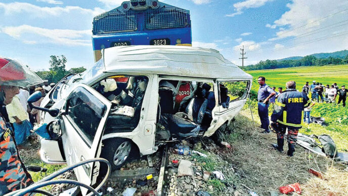 A mangled microbus lies on the rail track after the Chattogram-bound Mohanagar-Probhati Express hit the vehicle at Purba Khoiyachora jhorna level crossing in Mirsharai upazila yesterday afternoon. The train dragged the vehicle about one kilometre. Photo: Collected